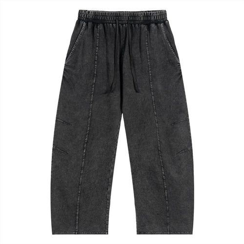 Black washed streetwear jogger pants with elastic waistband and stitched details, front view