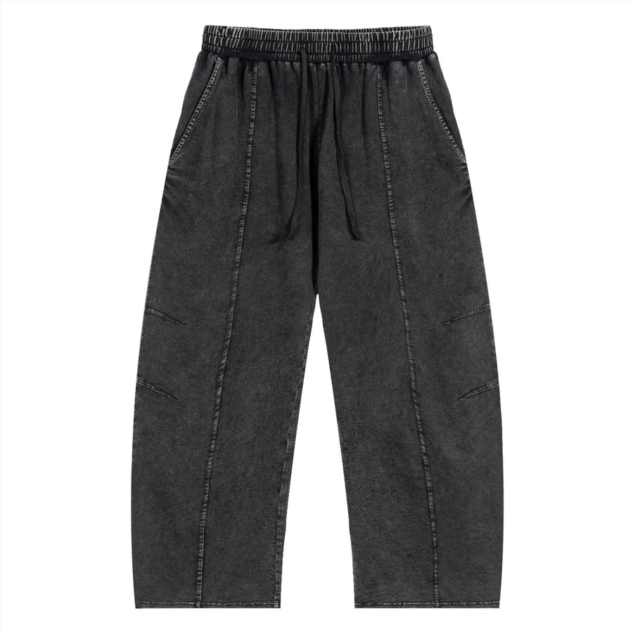 Black washed streetwear jogger pants with elastic waistband and stitched details, front view