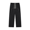 Black streetwear jogger pants with white drawstring and curved stitching, modern urban style