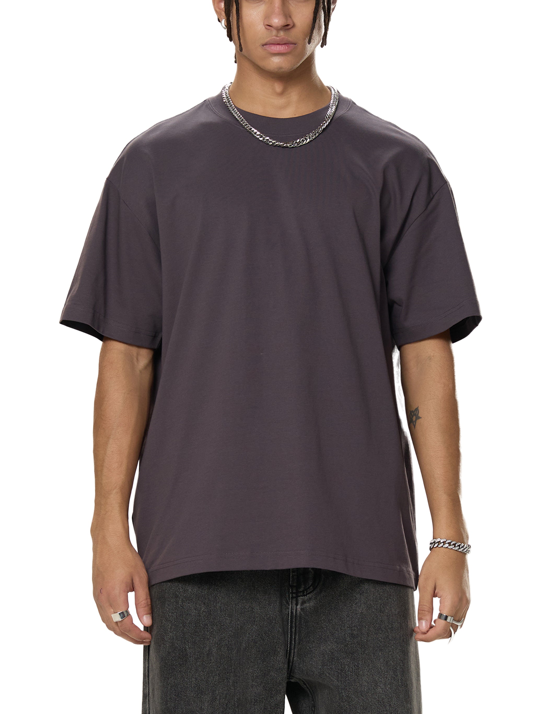 Male model wearing oversized dark grey streetwear t-shirt and chain necklace