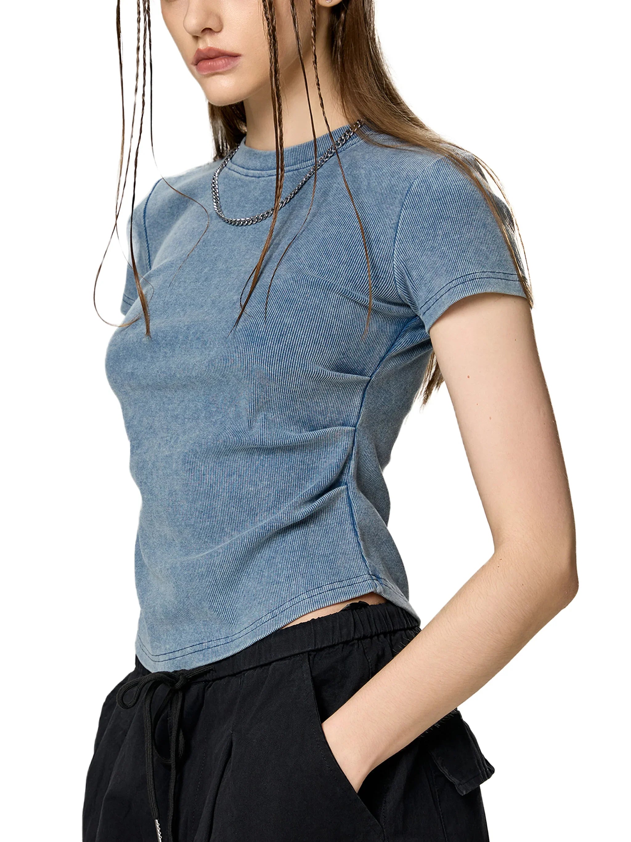 Woman wearing a fitted blue short sleeve t-shirt and black drawstring pants