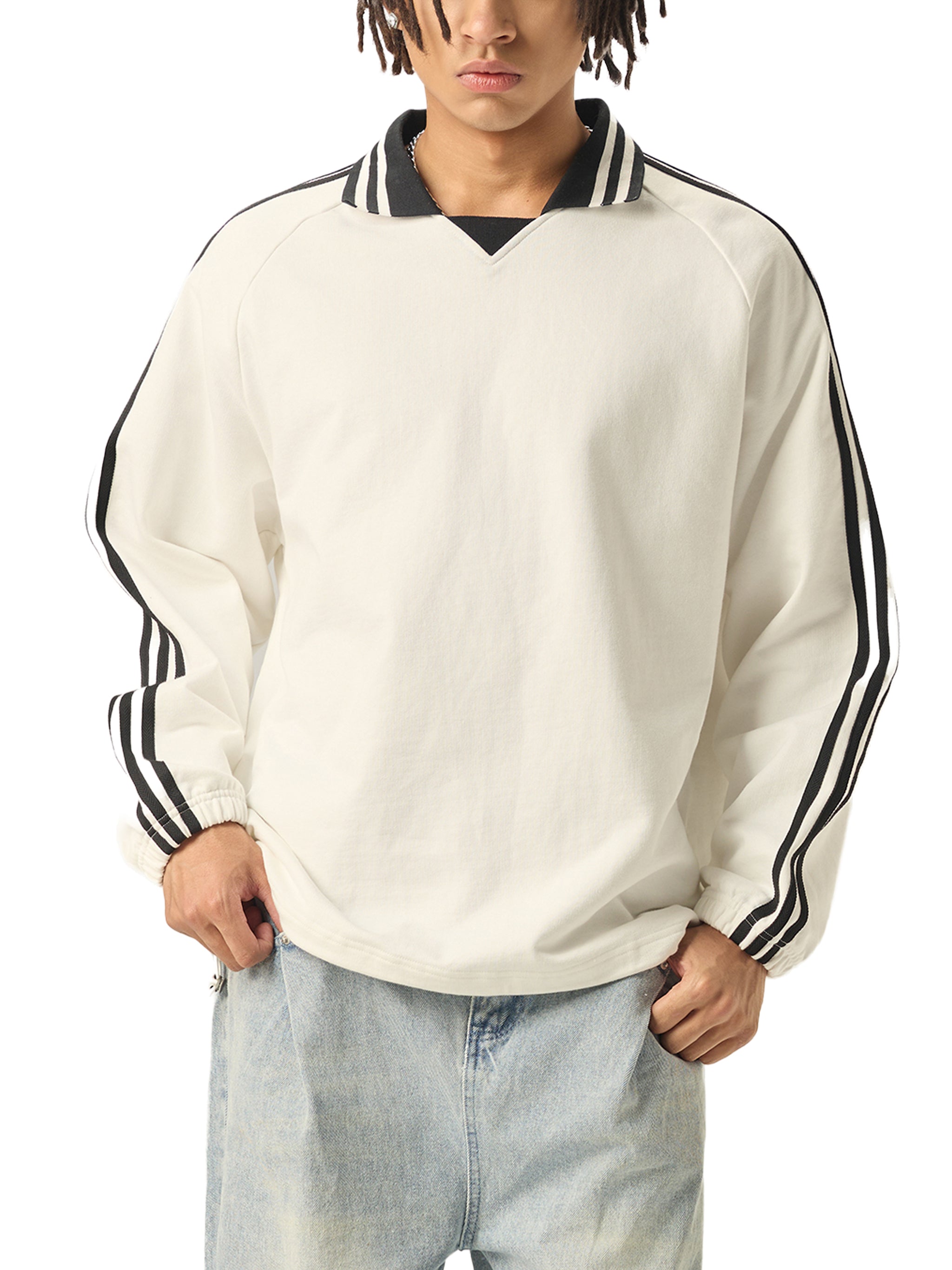 Oversized white streetwear sweatshirt with black striped collar and sleeves, paired with light denim jeans