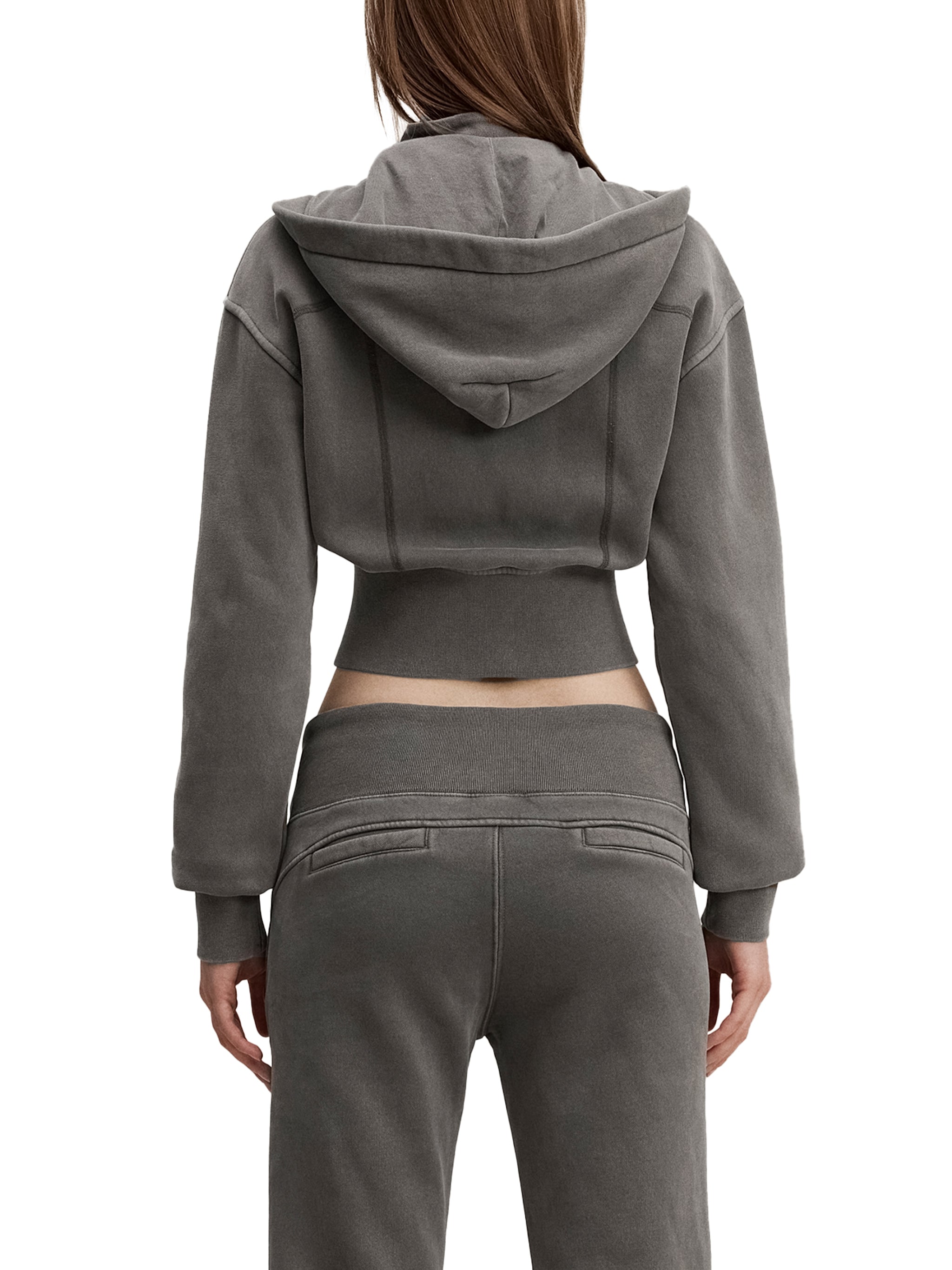 Back view of woman in gray cropped hoodie and matching sweatpants, modern streetwear